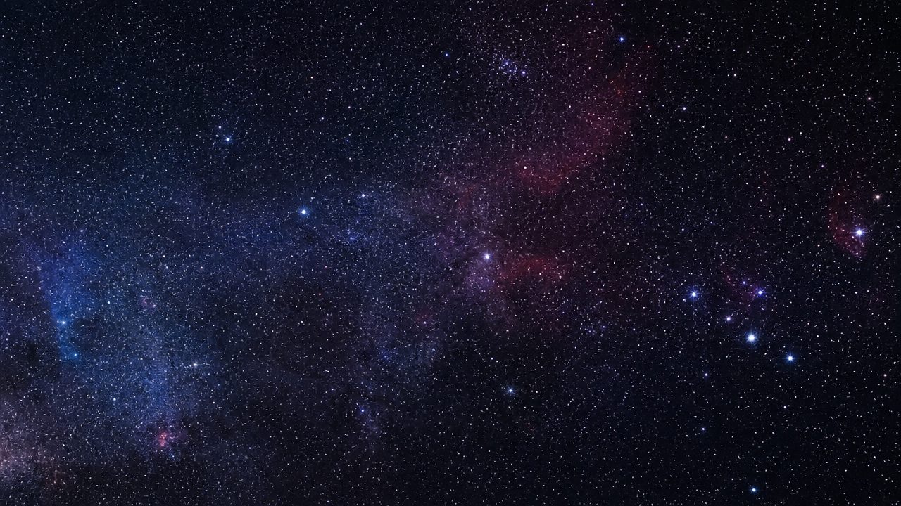 A field of stars and a glowing nebula